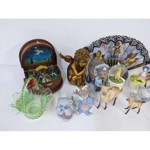 267 - A mixed lot to include a Danbury Mint Nativity music box, Nao figures, Beswick deer, and others Loca... 