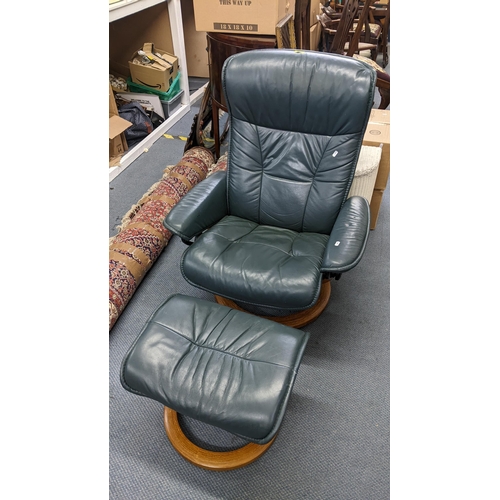 279 - An Ekaress green leather swivel armchair with a matching footstool
Location:A2B