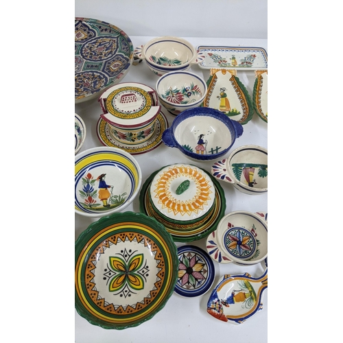 286 - A mixed lot to include a Moroccan ceramic charger, together with Quimper ware and stoneware bottles ... 