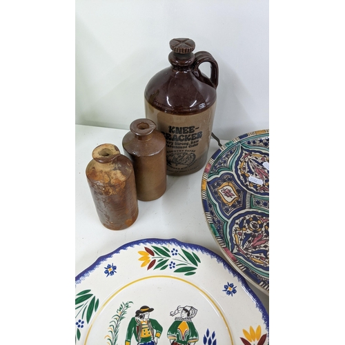 286 - A mixed lot to include a Moroccan ceramic charger, together with Quimper ware and stoneware bottles ... 