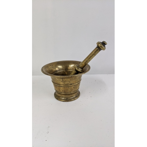 288 - A bronze pestle and mortar with turned tapered body Location:11.3