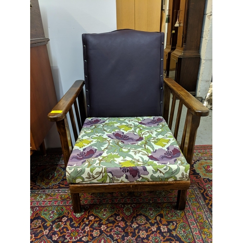 303 - A 1920s reclining armchair with stud upholstered back and a modern floral cushion
Location:RAM