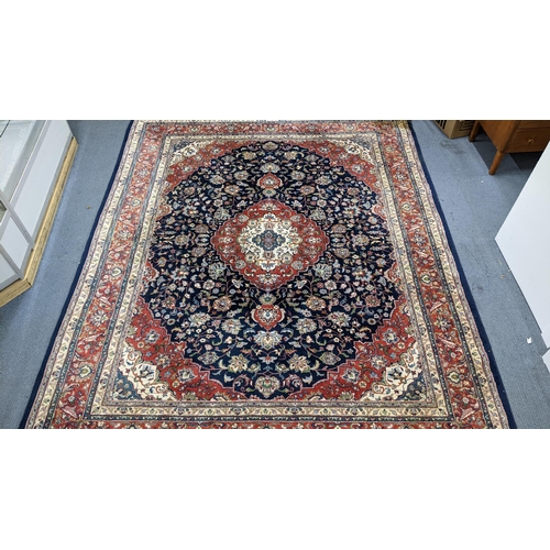 A Persian Tabriz hand woven rug having a central medallion in a navette shaped field with floral designs and multiguard borders, 302cm x 240cm
Location:A4B