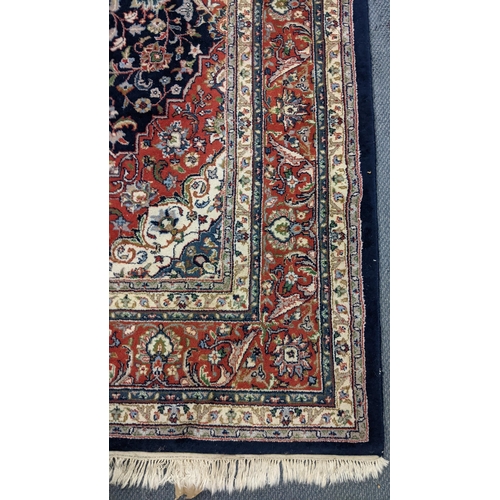 309 - A Persian Tabriz hand woven rug having a central medallion in a navette shaped field with floral des... 