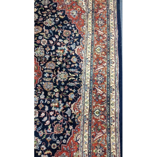 309 - A Persian Tabriz hand woven rug having a central medallion in a navette shaped field with floral des... 