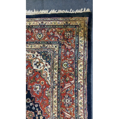 309 - A Persian Tabriz hand woven rug having a central medallion in a navette shaped field with floral des... 