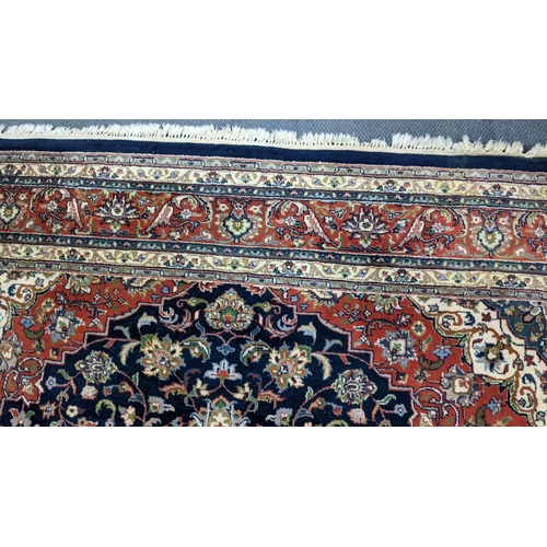 309 - A Persian Tabriz hand woven rug having a central medallion in a navette shaped field with floral des... 