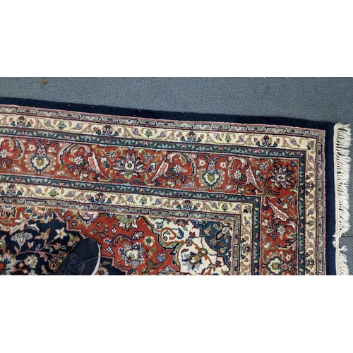 309 - A Persian Tabriz hand woven rug having a central medallion in a navette shaped field with floral des... 