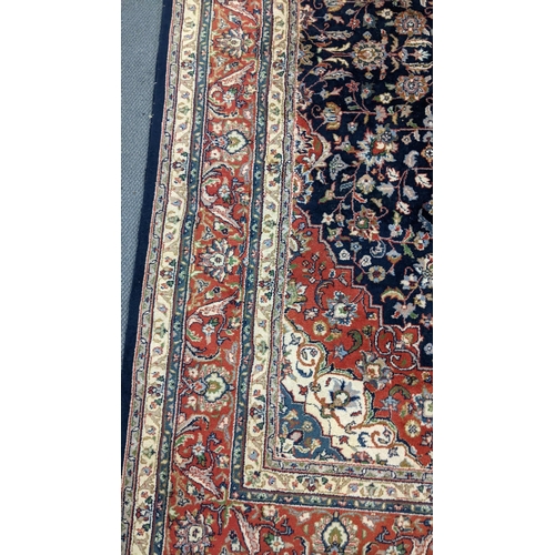 309 - A Persian Tabriz hand woven rug having a central medallion in a navette shaped field with floral des... 