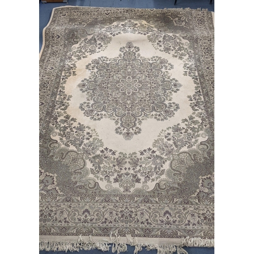 326 - A Super Keshan beige ground rug having a central motif with a floral design and tasselled ends, 346c... 