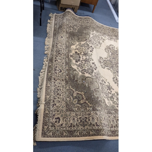 326 - A Super Keshan beige ground rug having a central motif with a floral design and tasselled ends, 346c... 