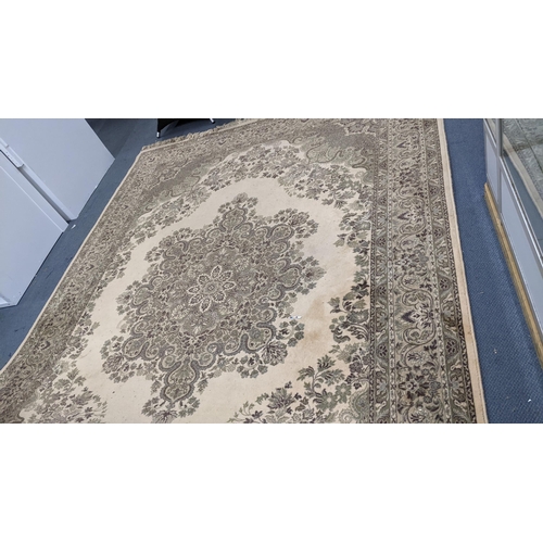 326 - A Super Keshan beige ground rug having a central motif with a floral design and tasselled ends, 346c... 