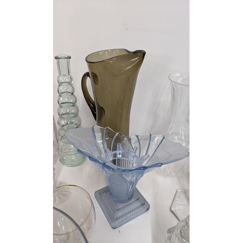 46 - Mixed glassware to include perfume bottles, a smoked glass jug, various vases and others
Location:RW... 