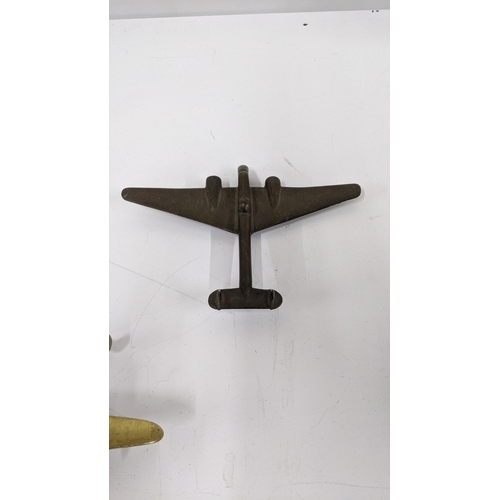 53 - A solid brass airplane door knocker, along with a WW2 brass model airplane
Location:8.2