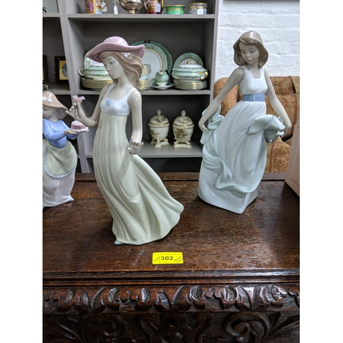 302 - Lladro and Nao Two Lladro bells and a Lladro collectors society plaque, also to include five Nao fig... 