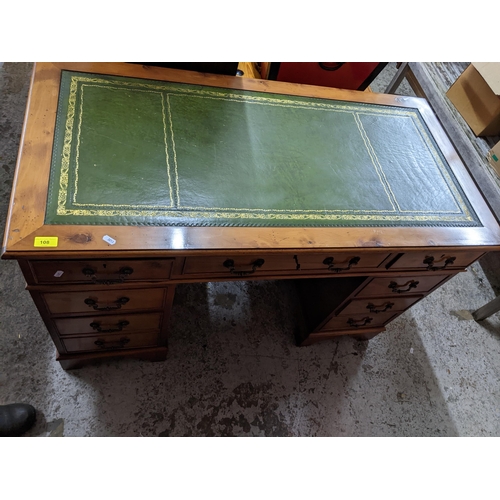 108 - A modern yew wood twin pedestal desk, gilt tooled green leather insert to top, central frieze drawer... 