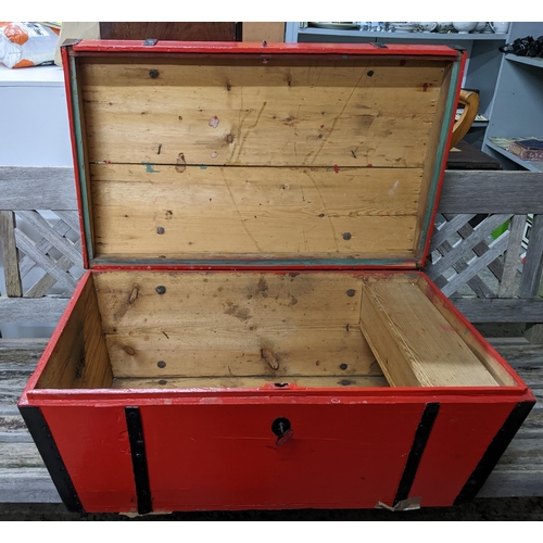 110 - A red painted pine doomed truck with wrought iron trap work, cast iron carrying handles, with hook a... 