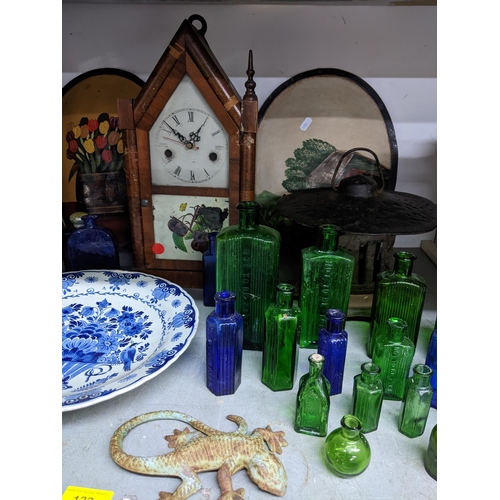 122 - A miscellaneous lot to include glass poison bottles, American mantel clock, painted metal ornamental... 