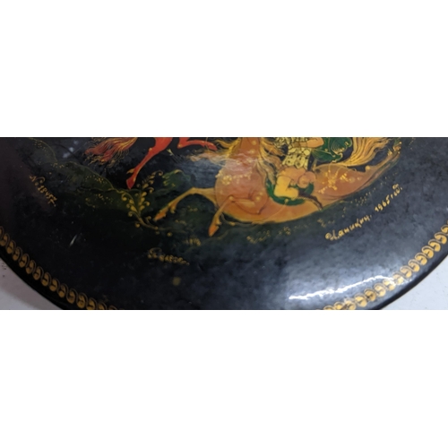 126 - A 1960s Russian lacquered paper mache circular box decorated with various figures on horseback numbe... 