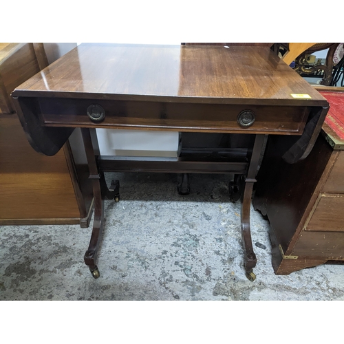 128 - A reproduction mahogany sofa table, single frieze drawer, splayed legs on brass castors 69x69 (when ... 