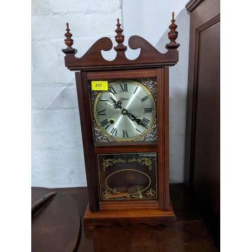 257 - A highlands mahogany cased wall hanging clock, the silvered Roman dial marked Highlands glazed pendu... 