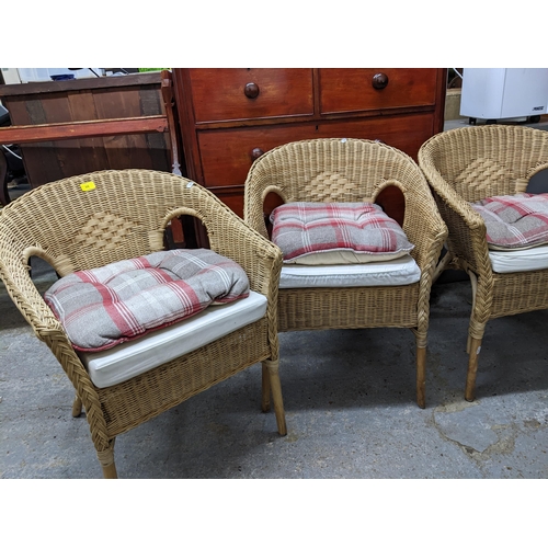 66 - Four wicker work armchairs with loose cushion seats Location:G