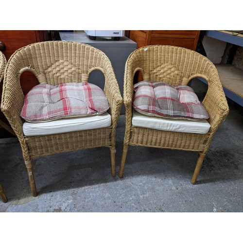 66 - Four wicker work armchairs with loose cushion seats Location:G