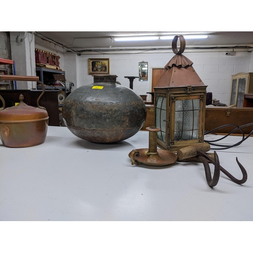 93 - A selection of metal ware to include an African water carrier metal bowl, copper porch light with gl... 