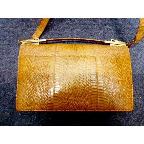 61 - A vintage snakeskin shoulder bag with gold tone hardware and corners, a snakeskin purse, a Kate Land... 