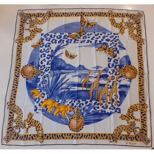 2 - Cartier-A silk African Savanna scarf having a pale grey ground and a border with images of jewel emb... 