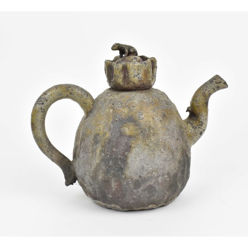 473 - A Chinese stoneware teapot of naturalistic form with ruched opening and lid mounted with an animal o... 