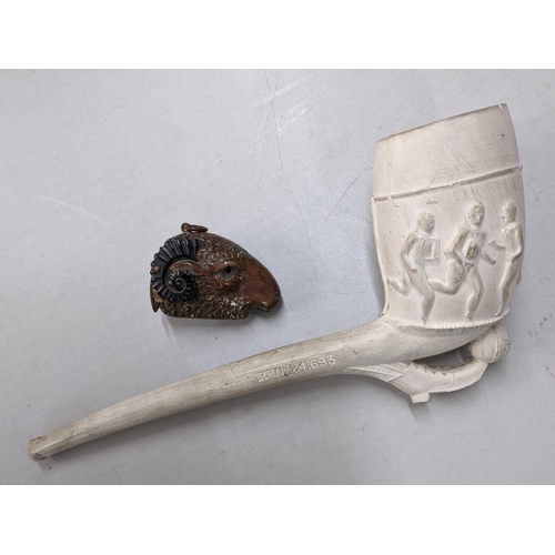 410 - A 19th/20th century clay pipe with a football scene and rugby scene to the other side, and a copper ... 