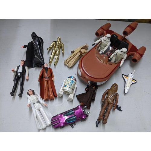 414 - A collection of Star Wars toys to include C3PO, R2D2, Obi Wan Kenobi, Darth, and others, together wi... 