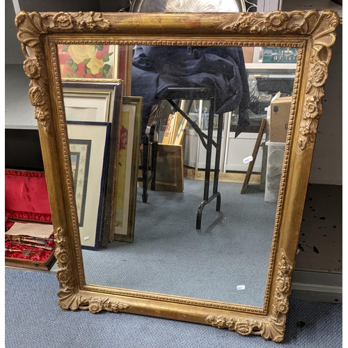 420 - A vintage gilt wall hanging mirror having a moulded floral frame 88cm h x 76cm w Location:A4B