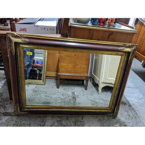 405 - A contemporary gilt and mahogany effect gilt gesso and wood framed wall mirror with rectangular beve... 