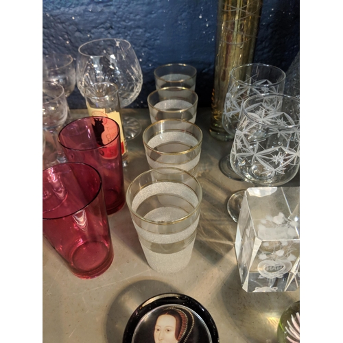 264 - Mixed glassware to include a claret jug with a silver plated top, paperweights, and other items Loca... 