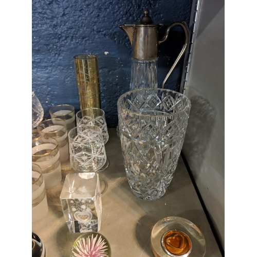 264 - Mixed glassware to include a claret jug with a silver plated top, paperweights, and other items Loca... 