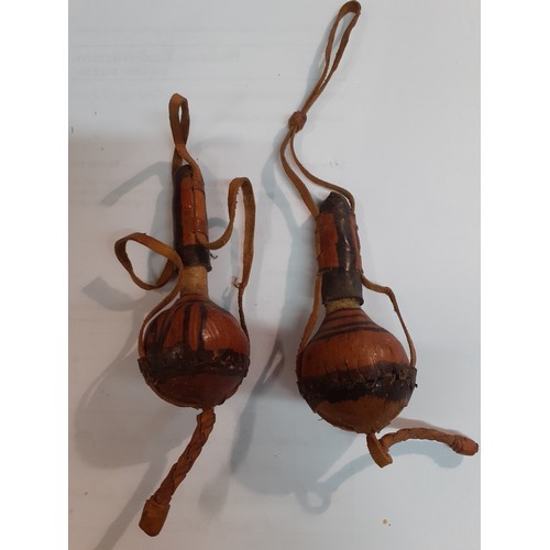 158 - A pair of 1940's Hausa antimony eye make-up containers with leather cord handles  together with  a 1... 