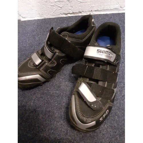 157 - A pair of gents Shimano black and silver cycle shoes, size 44 with cleats together with a Bell black... 