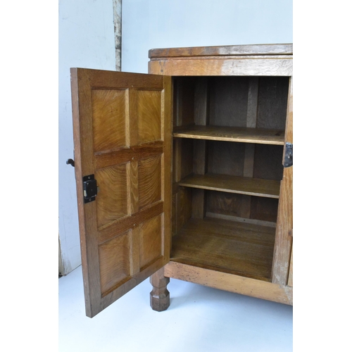 56 - Robert 'Mouseman' Thompson (1876-1955) An oak panelled sideboard, circa 1955, adzed throughout, rais... 