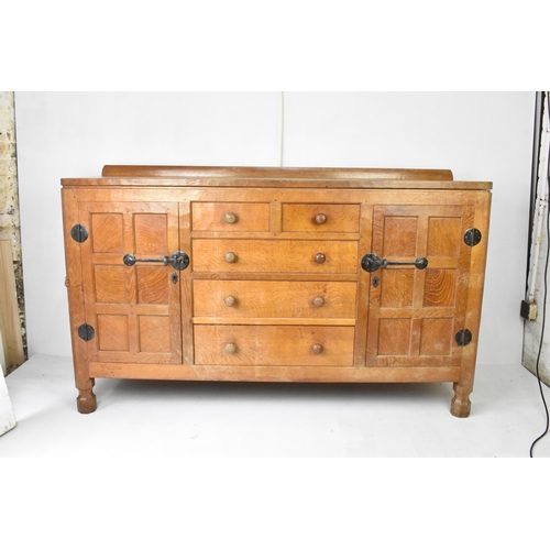 56 - Robert 'Mouseman' Thompson (1876-1955) An oak panelled sideboard, circa 1955, adzed throughout, rais... 