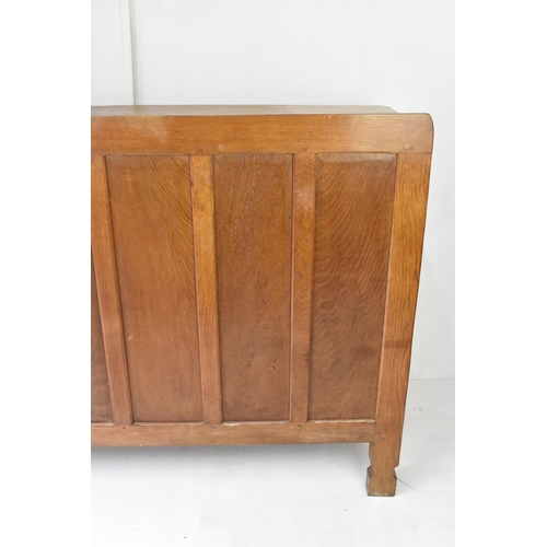 56 - Robert 'Mouseman' Thompson (1876-1955) An oak panelled sideboard, circa 1955, adzed throughout, rais... 