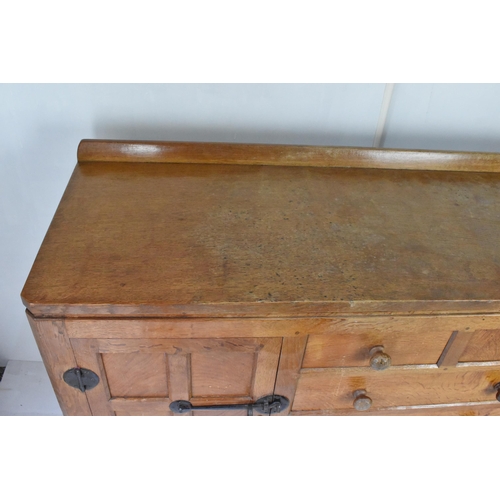 56 - Robert 'Mouseman' Thompson (1876-1955) An oak panelled sideboard, circa 1955, adzed throughout, rais... 