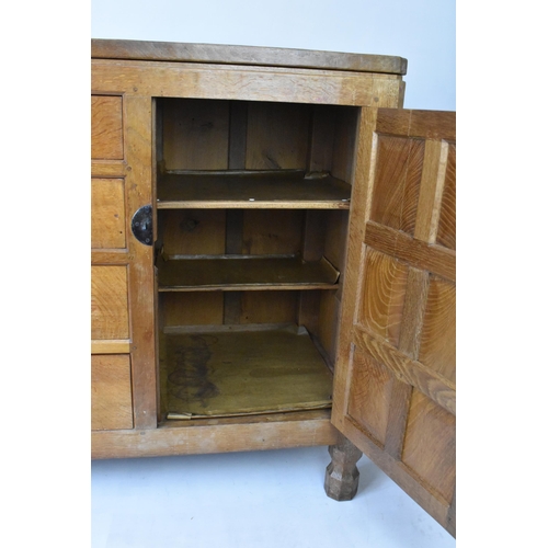 56 - Robert 'Mouseman' Thompson (1876-1955) An oak panelled sideboard, circa 1955, adzed throughout, rais... 