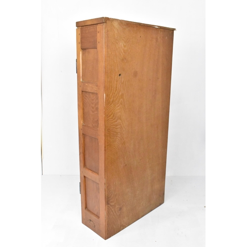 57 - Robert 'Mouseman' Thompson (1876-1955) An oak hanging corner cupboard, circa 1955, with panelled doo... 