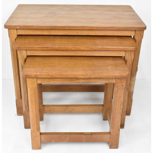 58 - Robert 'Mouseman' Thompson (1876-1955) A nest of three graduating oak 'Mouseman' tables, circa 1979,... 