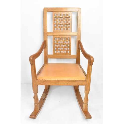 59 - Robert 'Mouseman' Thompson (1876-1955) An oak rocking chair, circa 1974, with two lattice panel back... 