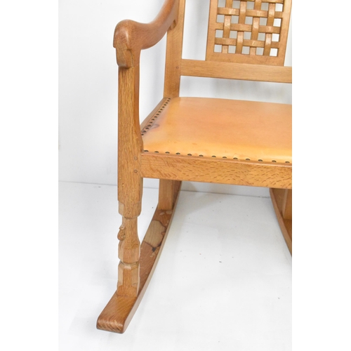 59 - Robert 'Mouseman' Thompson (1876-1955) An oak rocking chair, circa 1974, with two lattice panel back... 