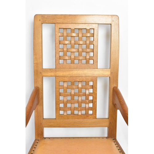 59 - Robert 'Mouseman' Thompson (1876-1955) An oak rocking chair, circa 1974, with two lattice panel back... 