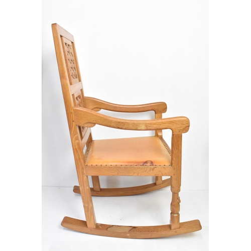 59 - Robert 'Mouseman' Thompson (1876-1955) An oak rocking chair, circa 1974, with two lattice panel back... 